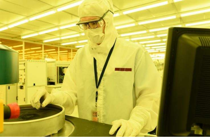 佐治亚理工学院的研究生助理Mason Chilmonczyk在反应离子蚀刻工具中的等离子体蚀刻步骤之后检查器件。这项工作正在电子和纳米技术研究所的Marcus Building洁净室进行。图片来源：乔治亚理工学院的Rob Felt